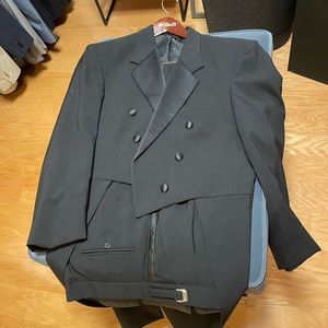 Swallow tail notched dinner jacket and tuxedo pants.